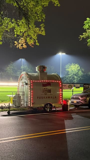 FuskaWala food cart lit up at night at Westside Park in Paterson, NJ